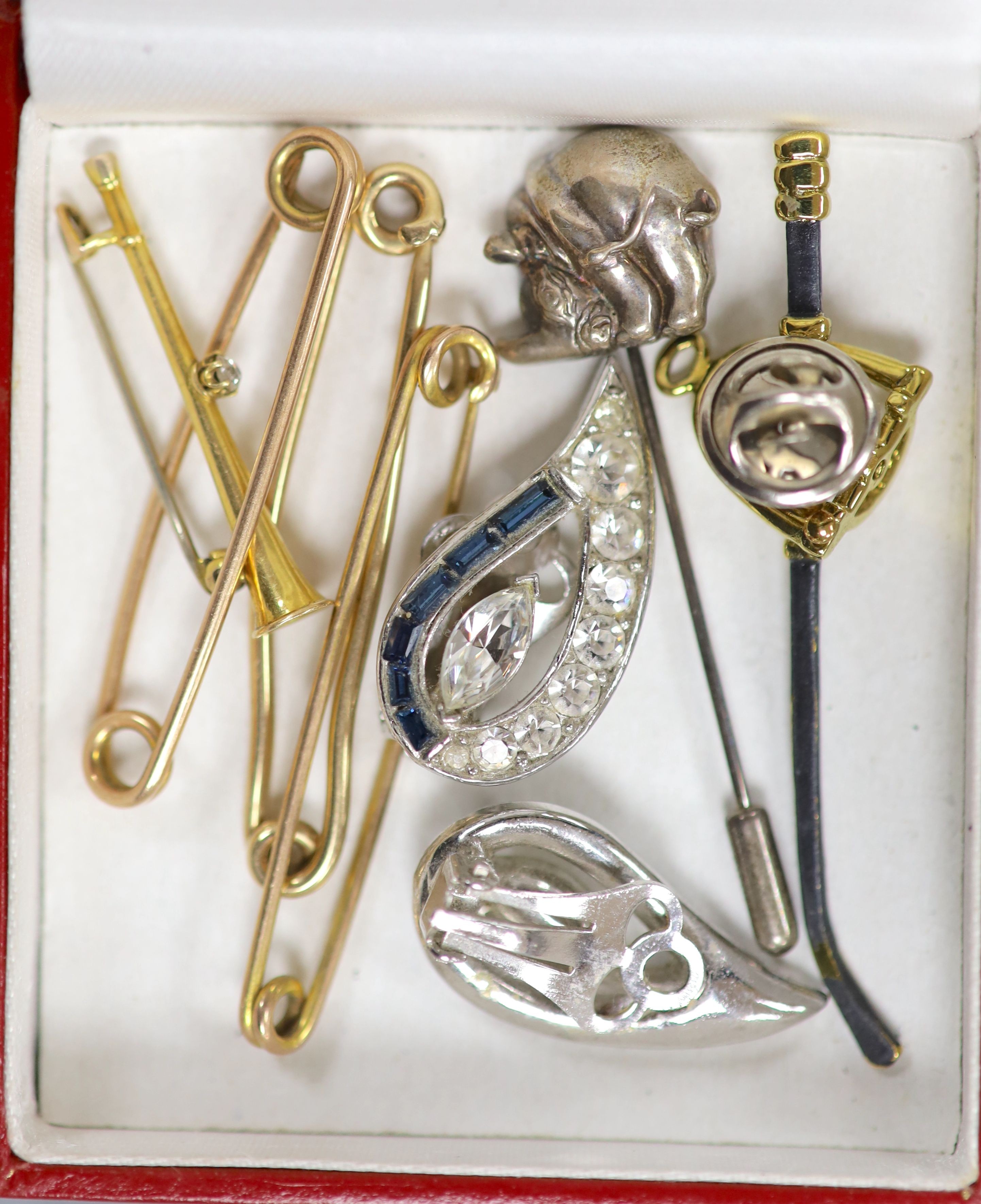 A yellow metal and diamond set hunting horn bar brooch, 34mm, gross 1.9 grams, two 9ct pins, 5.8 grams, two other pins, a riding crop and stirrup ear stud?, a white metal rhinoceros pin and pair of paste ear clips.